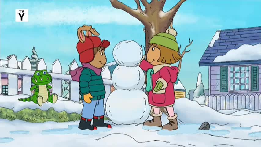 Two kids are building a snowman in the snow, with a green alligator watching from the side. It looks like a typical day for kids in Australia, maybe during a rare cold snap.