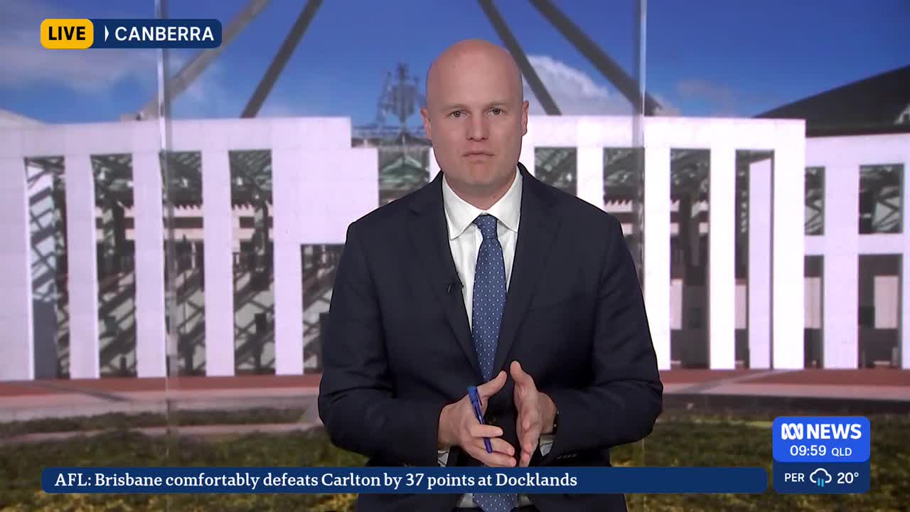 A man in a suit stands in front of a building, speaking directly to the camera. The ABC News logo and the time are displayed in the lower right corner.
