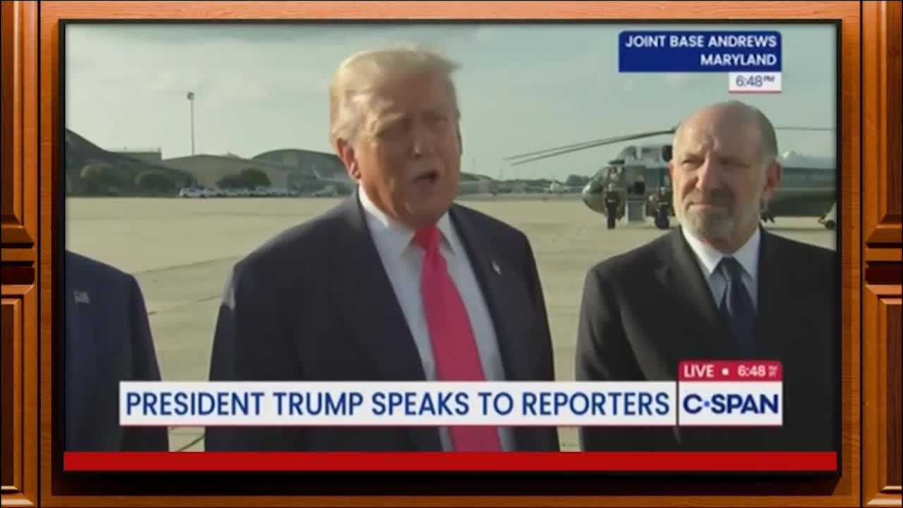 The former president, wearing a pink tie, is speaking directly to the camera, standing on an airfield. A helicopter and a man in a suit stand behind him, as the broadcast is live on C-SPAN.
