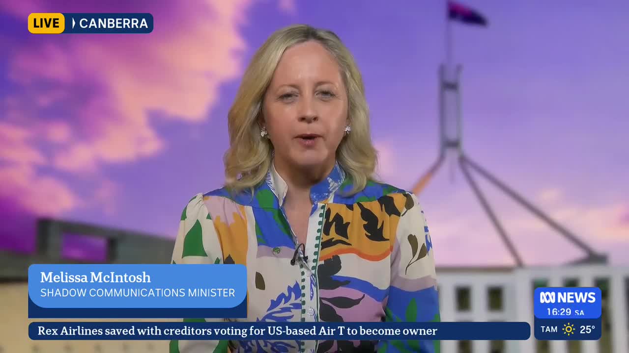 The ABC News presenter, Melissa McIntosh, is speaking directly to the camera from Canberra. Behind her, the Australian Parliament House is visible against a dusky sky.
The ABC News presenter, Melissa McIntosh, is speaking directly to the camera from Canberra. Behind her, the Australian Parliament House is visible against a dusky sky.