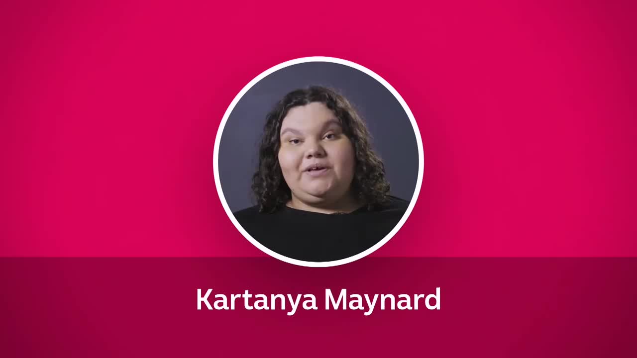In a circular frame, Kartanya Maynard is speaking, her face framed by dark, curly hair. Below, her name is displayed against a deep pink background, likely from ABC Australia.
In a circular frame, Kartanya Maynard is speaking, her face framed by dark, curly hair. Below, her name is displayed against a deep pink background, likely from ABC Australia.