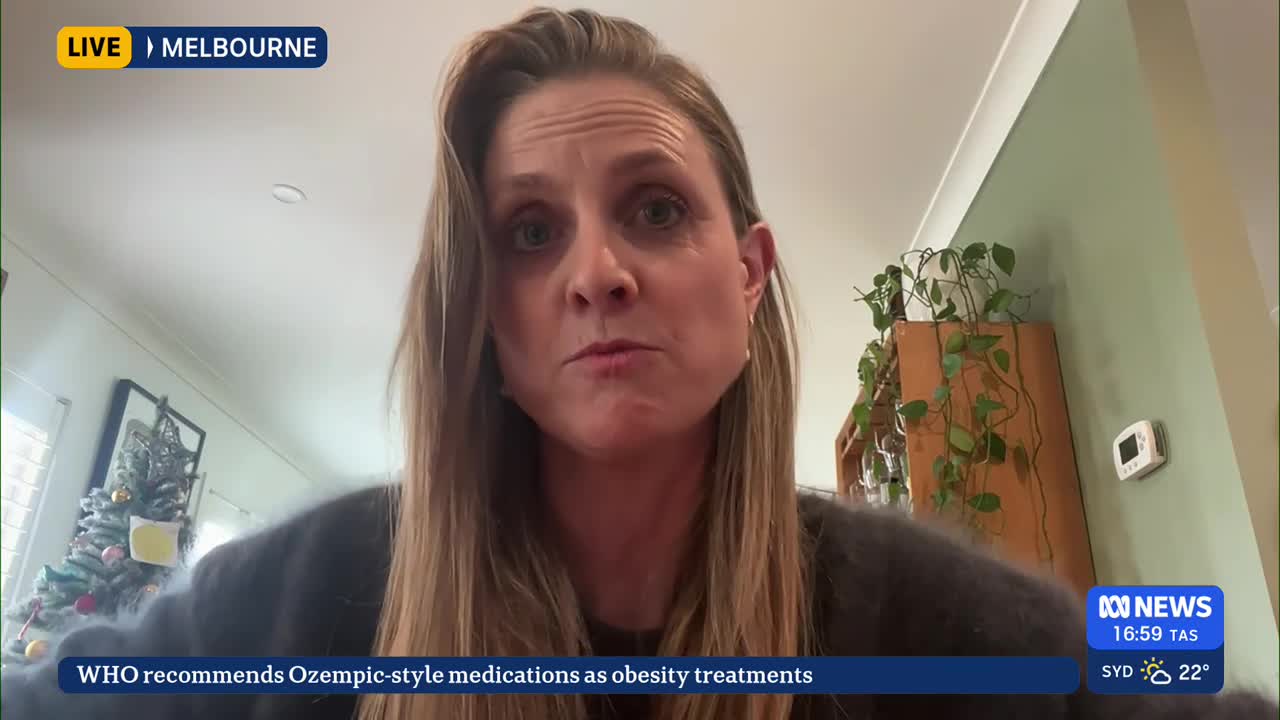 A woman with long blonde hair is speaking directly into the camera, likely for ABC News in Australia. Behind her, a small Christmas tree and some potted plants are visible.
A woman with long blonde hair is speaking directly into the camera, likely for ABC News in Australia. Behind her, a small Christmas tree and some potted plants are visible.