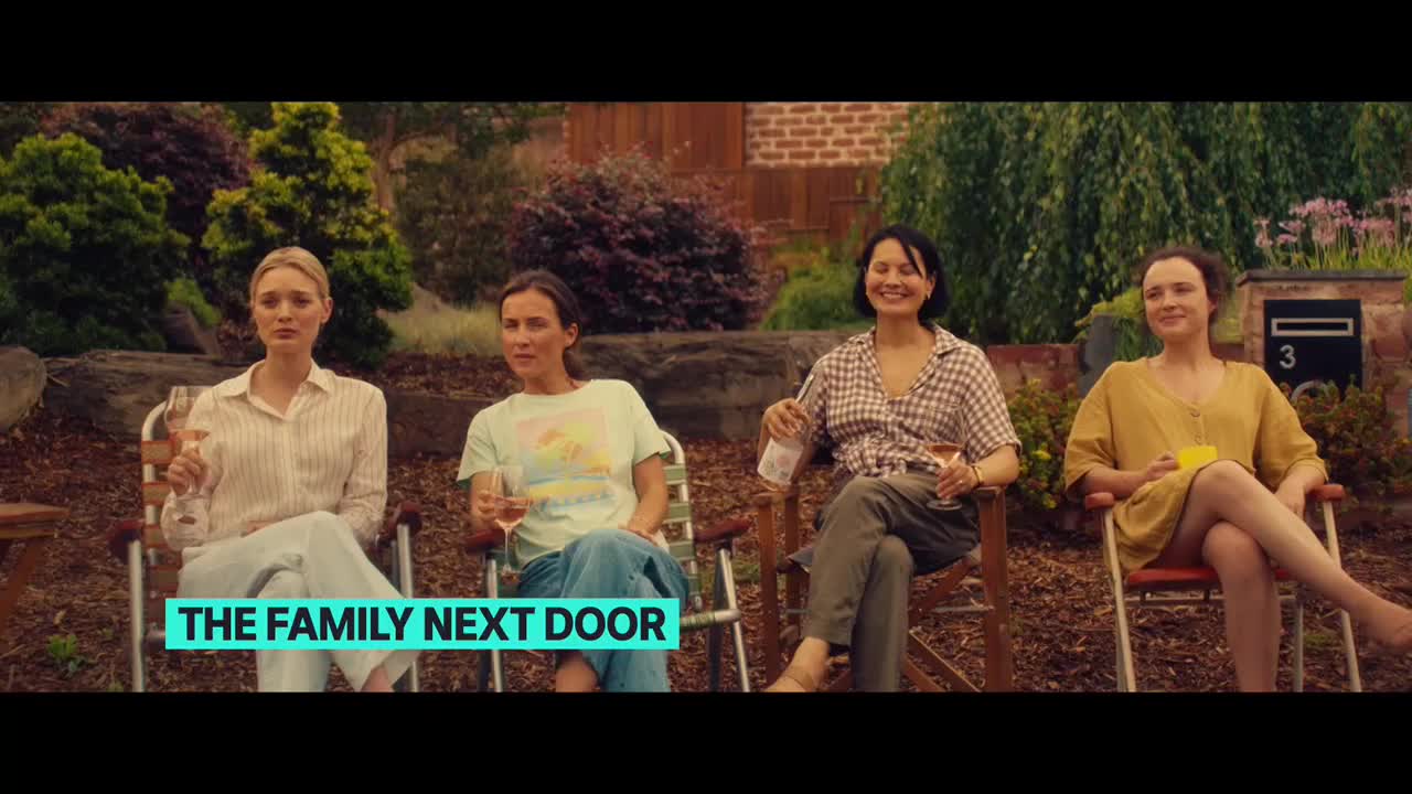 Four women are seated in folding chairs, each holding a glass of wine. They're in a backyard, the house number visible on a mailbox behind them.
Four women are seated in folding chairs, each holding a glass of wine. They're in a backyard, the house number visible on a mailbox behind them.