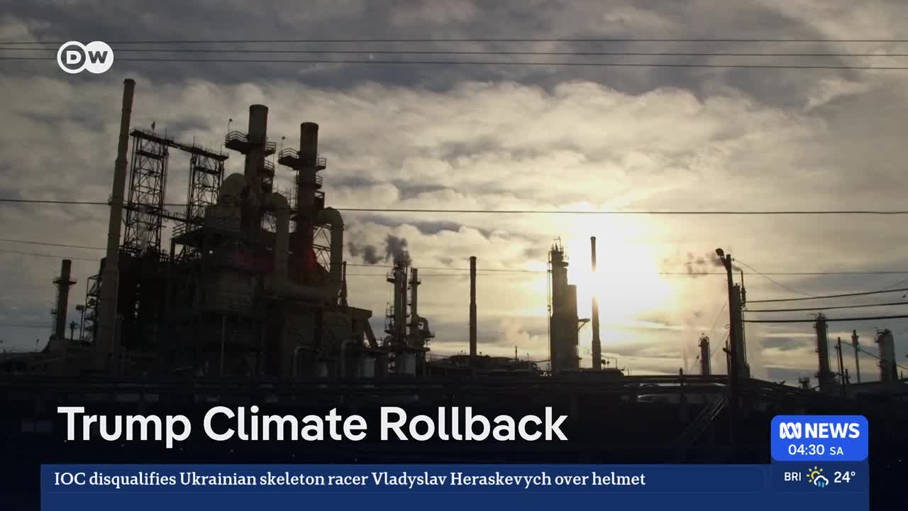 Smoke plumes rise from tall stacks at an industrial complex against a hazy, sunlit sky. The ABC News graphic at the bottom indicates this is a report from Australia.