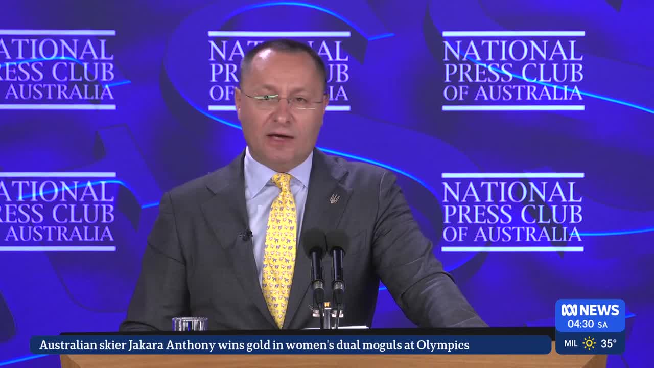 A man in a suit speaks at a podium, with the National Press Club of Australia logo behind him. The ABC News ticker at the bottom reports on Jakara Anthony's Olympic gold medal win.