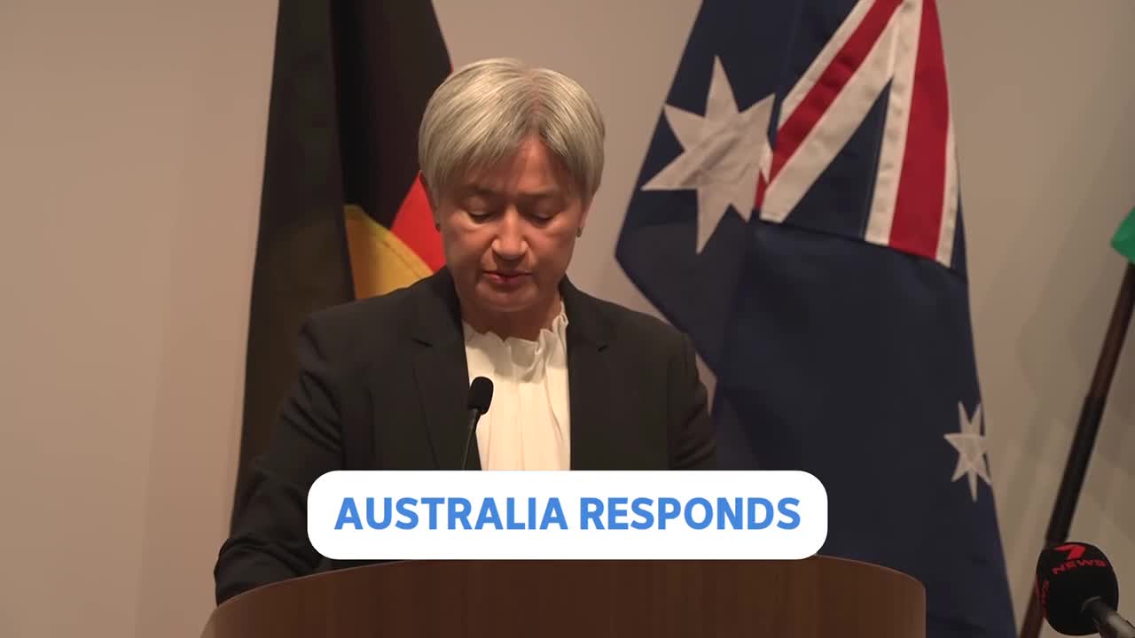 A woman stands at a podium, speaking into a microphone with the Australian flag behind her. A graphic overlay reads "AUSTRALIA RESPONDS." A woman stands at a podium, speaking into a microphone with the Australian flag behind her. A graphic overlay reads "AUSTRALIA RESPONDS."