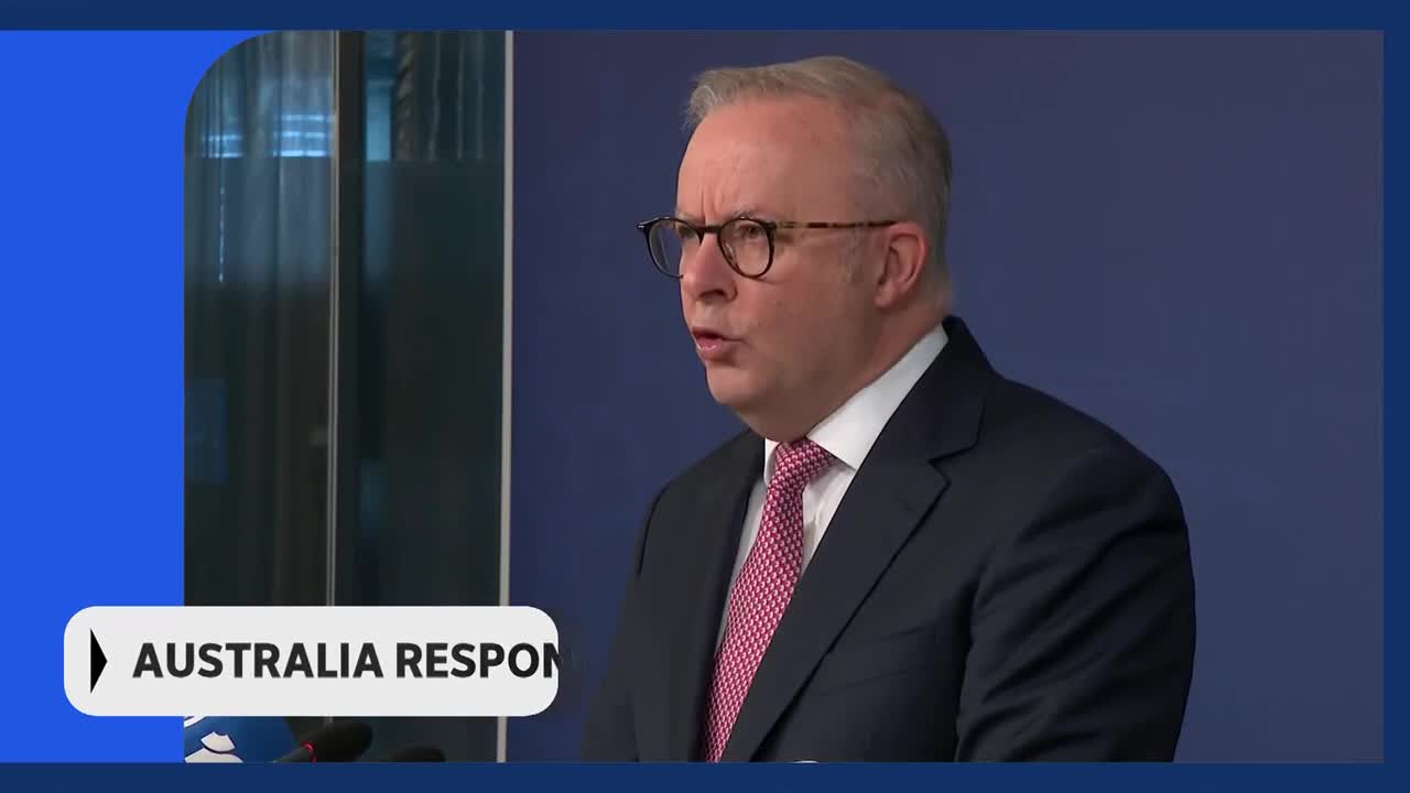 The Prime Minister is speaking, his tie a bright pink against his dark suit. A graphic overlay reads "AUSTRALIA RESPON". The Prime Minister is speaking, his tie a bright pink against his dark suit. A graphic overlay reads "AUSTRALIA RESPON".