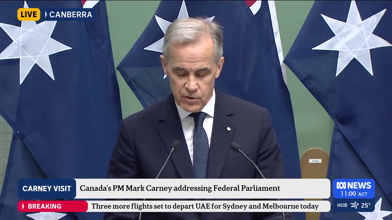Canada's Prime Minister Mark Carney stands at a podium, speaking before Australian flags. A chyron below indicates he is addressing Federal Parliament, with a breaking news alert about flights to Sydney and Melbourne.
