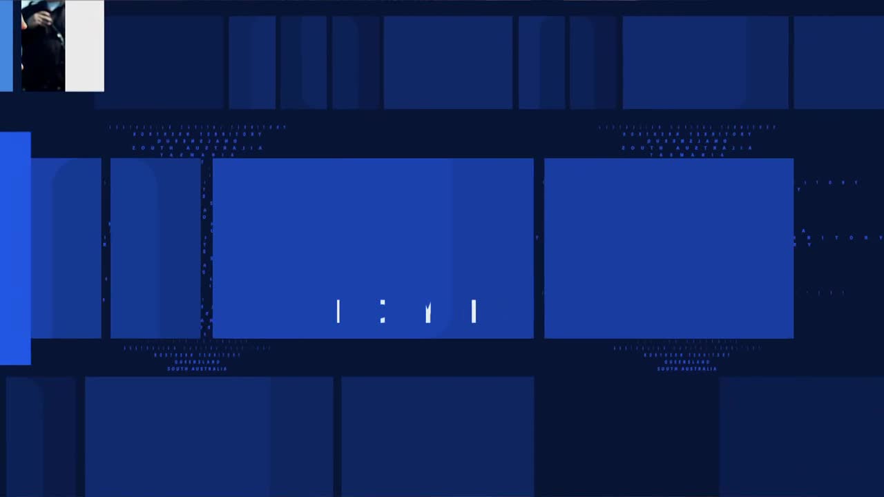 A man in a dark suit stands on a stage, bathed in light. The ABC Australia logo appears on screen.