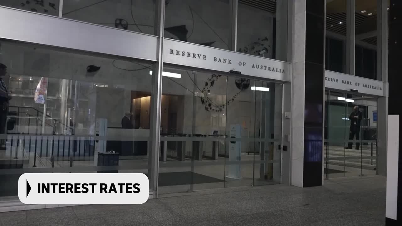 The Reserve Bank of Australia building stands before me, its glass doors reflecting the night. A security guard stands watch inside the entrance. The Reserve Bank of Australia building stands before me, its glass doors reflecting the night. A security guard stands watch inside the entrance.