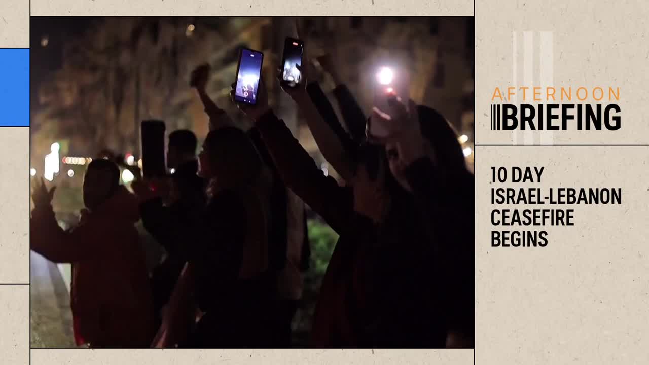 A crowd of people raise their phones, their screens and flashlights illuminating the night. It looks like they're celebrating something significant, perhaps news from ABC Australia.