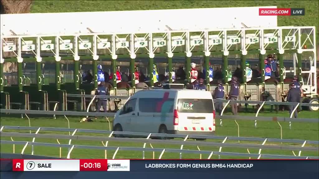 The horses are loaded in the starting gates, jockeys in colorful silks. A white van sits on the track, and the countdown clock ticks down on Racing.com.
