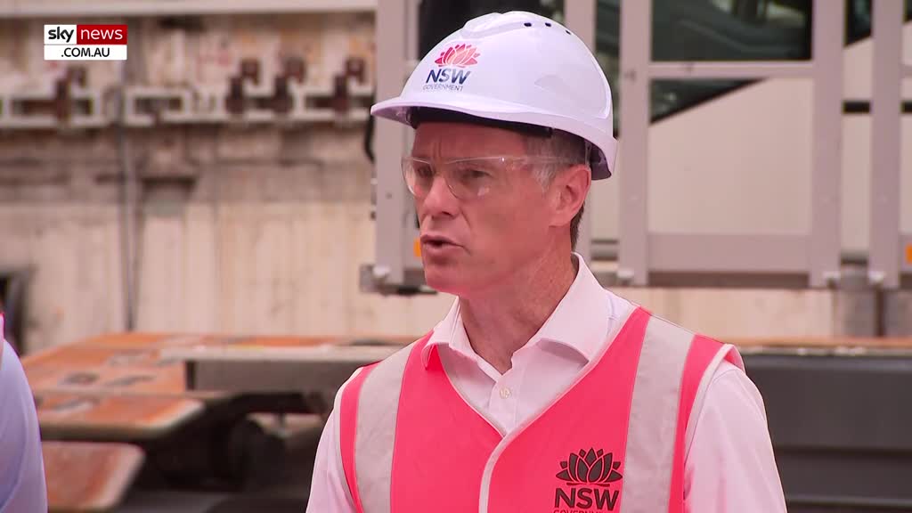 A man in a white hard hat and a bright pink hi-vis vest speaks at a construction site. The Sky News Extra logo is visible in the corner of the screen.