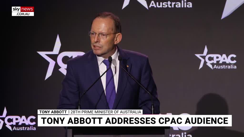 Tony Abbott, in a navy suit and purple tie, speaks into two microphones at a CPAC Australia event. The Sky News Extra 3 logo is visible in the corner.
