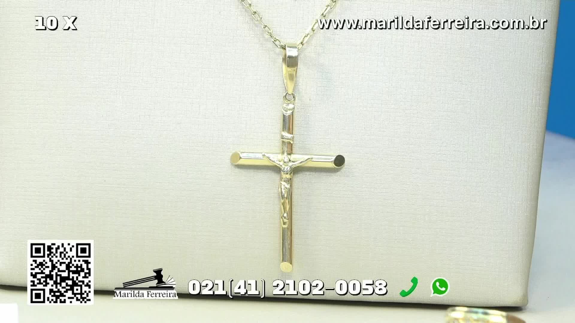 A gold crucifix pendant hangs centered against a neutral backdrop, its chain barely visible. The Canal Rural logo and contact information for Marilda Ferreira are displayed below.
