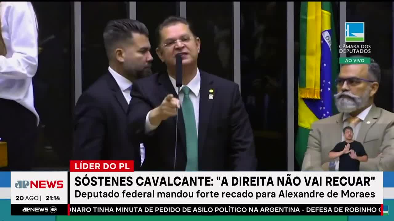 A man in a suit, holding a microphone, is pointing directly at the camera, his expression intense. The Jovem Pan News banner at the bottom highlights a statement from Sóstenes Cavalcante, a federal deputy in Brazil.
