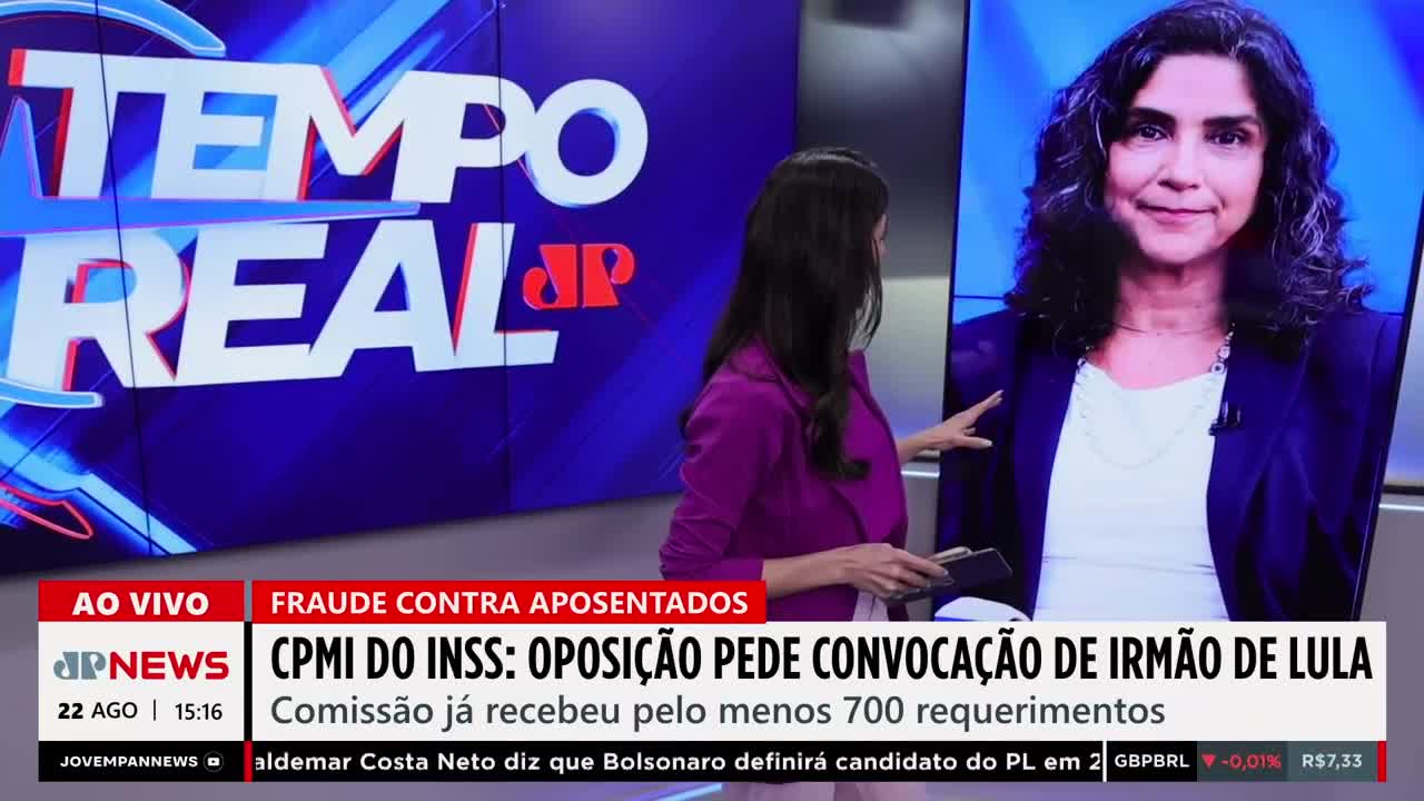 A woman in a magenta jacket gestures towards a screen displaying a woman's face. The Jovem Pan News broadcast is reporting on a commission's request for the brother of Lula.
