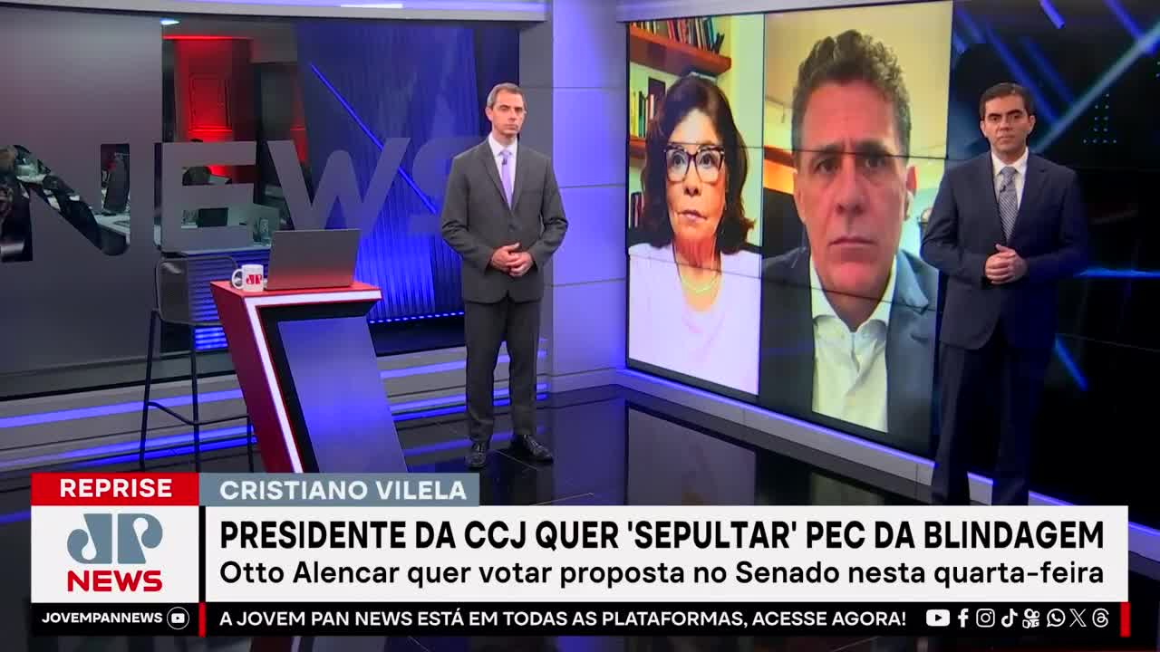 Two men in suits stand on either side of a screen displaying a news segment from Jovem Pan News. The headline in Portuguese discusses a proposal in the Senate.
