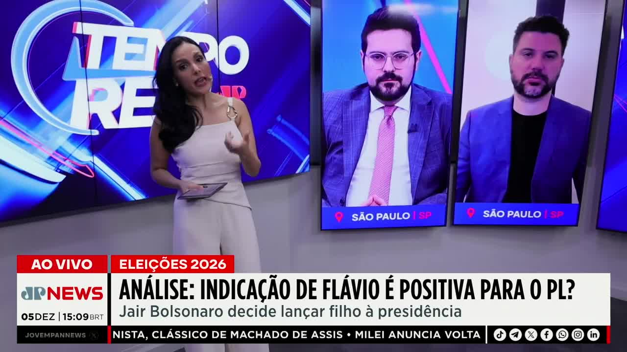 A woman in a cream-colored jumpsuit gestures with her hands as she speaks on the Jovem Pan News set. Behind her, two men in suits appear on screens, both with "São Paulo" displayed below.
A woman in a cream-colored jumpsuit gestures with her hands as she speaks on the Jovem Pan News set. Behind her, two men in suits appear on screens, both with "São Paulo" displayed below.
