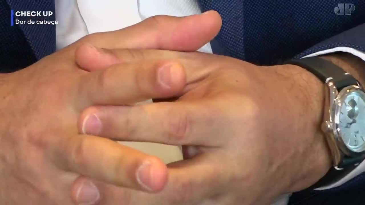 Fingers interlace, a man's hands clasped. A silver watch gleams on his wrist, its face catching the light. Fingers interlace, a man's hands clasped. A silver watch gleams on his wrist, its face catching the light.