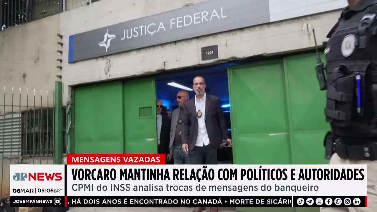 Men in suits exit the Justiça Federal building, one with a badge clipped to his jacket. A uniformed officer stands guard to the right, his tactical vest equipped with a radio.