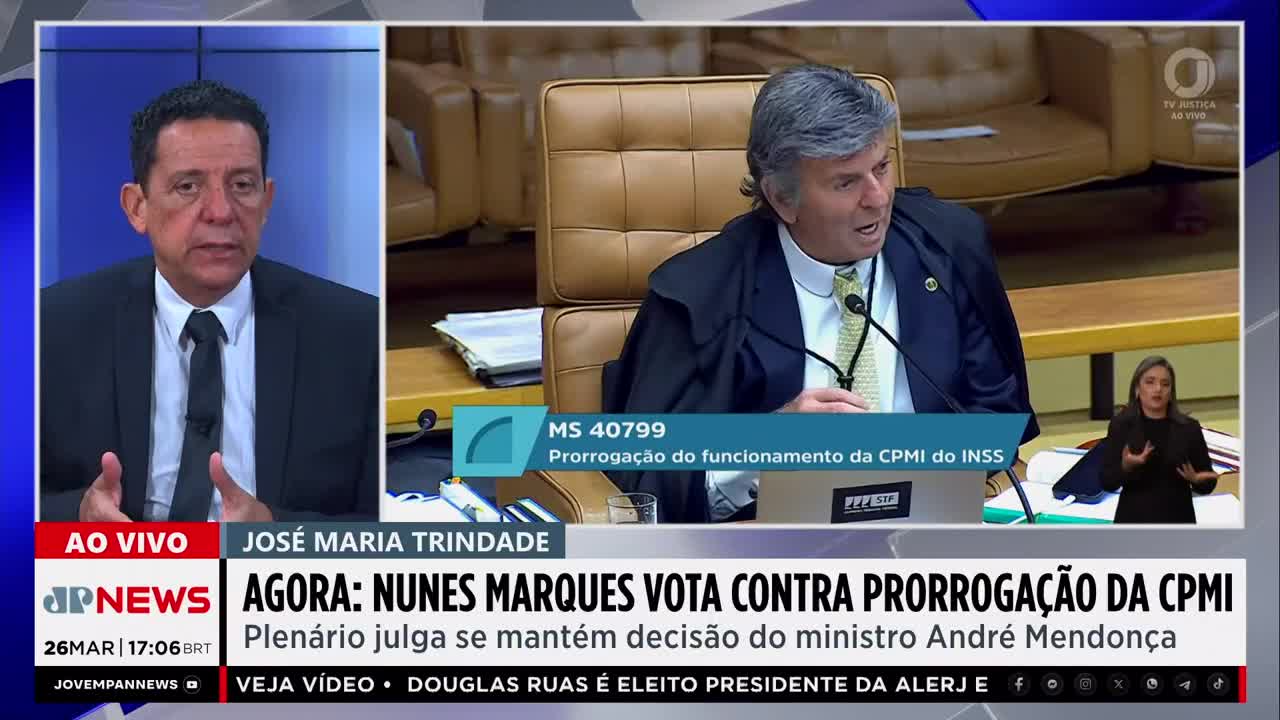 A man in a dark robe gestures emphatically while speaking, his face animated. Below him, a news chyron from Jovem Pan News announces a vote against extending a commission's term. A man in a dark robe gestures emphatically while speaking, his face animated. Below him, a news chyron from Jovem Pan News announces a vote against extending a commission's term.