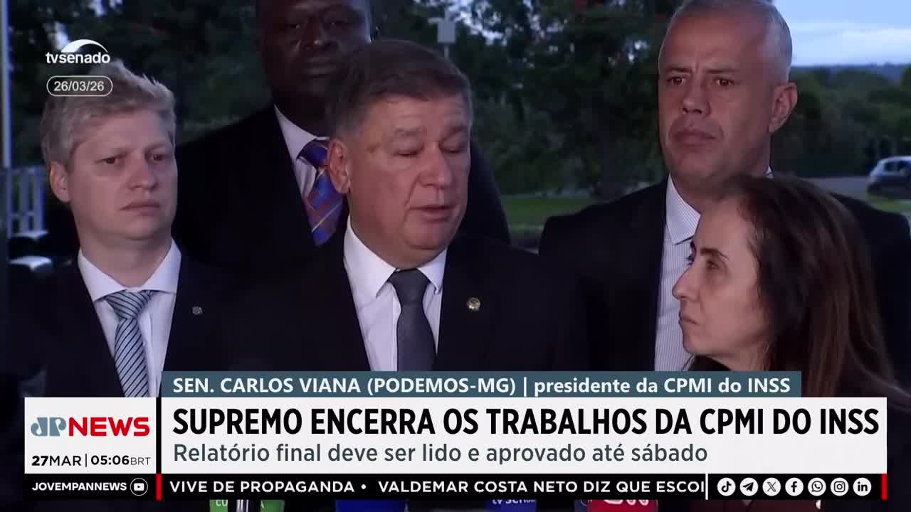 Senator Carlos Viana speaks to reporters, his face serious. Behind him, other officials stand, their expressions equally grave. Senator Carlos Viana speaks to reporters, his face serious. Behind him, other officials stand, their expressions equally grave.