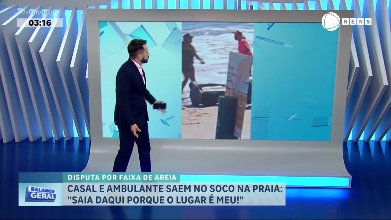 On a Brazilian news program, a man in a suit walks across the studio set, gesturing towards a screen. The screen shows a beach scene where a couple and a street vendor are arguing.
