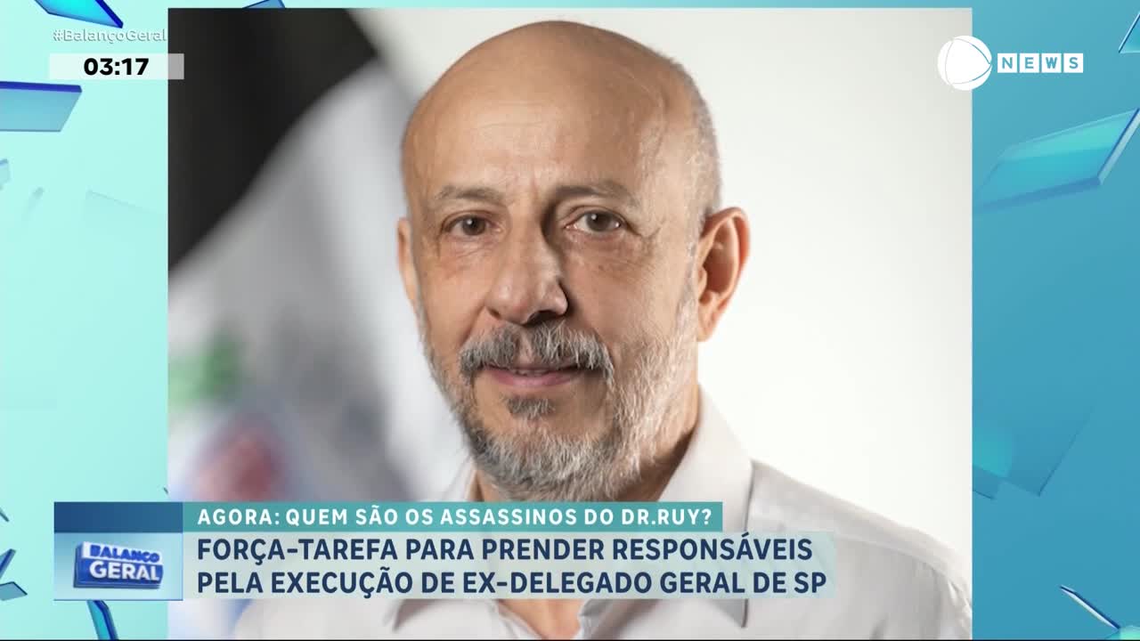 A man with a shaved head and a gray beard stares directly at the camera, his image featured on Record News. The broadcast from Brazil's "Balanço Geral" program is reporting on the murder of an ex-general delegate in São Paulo.
