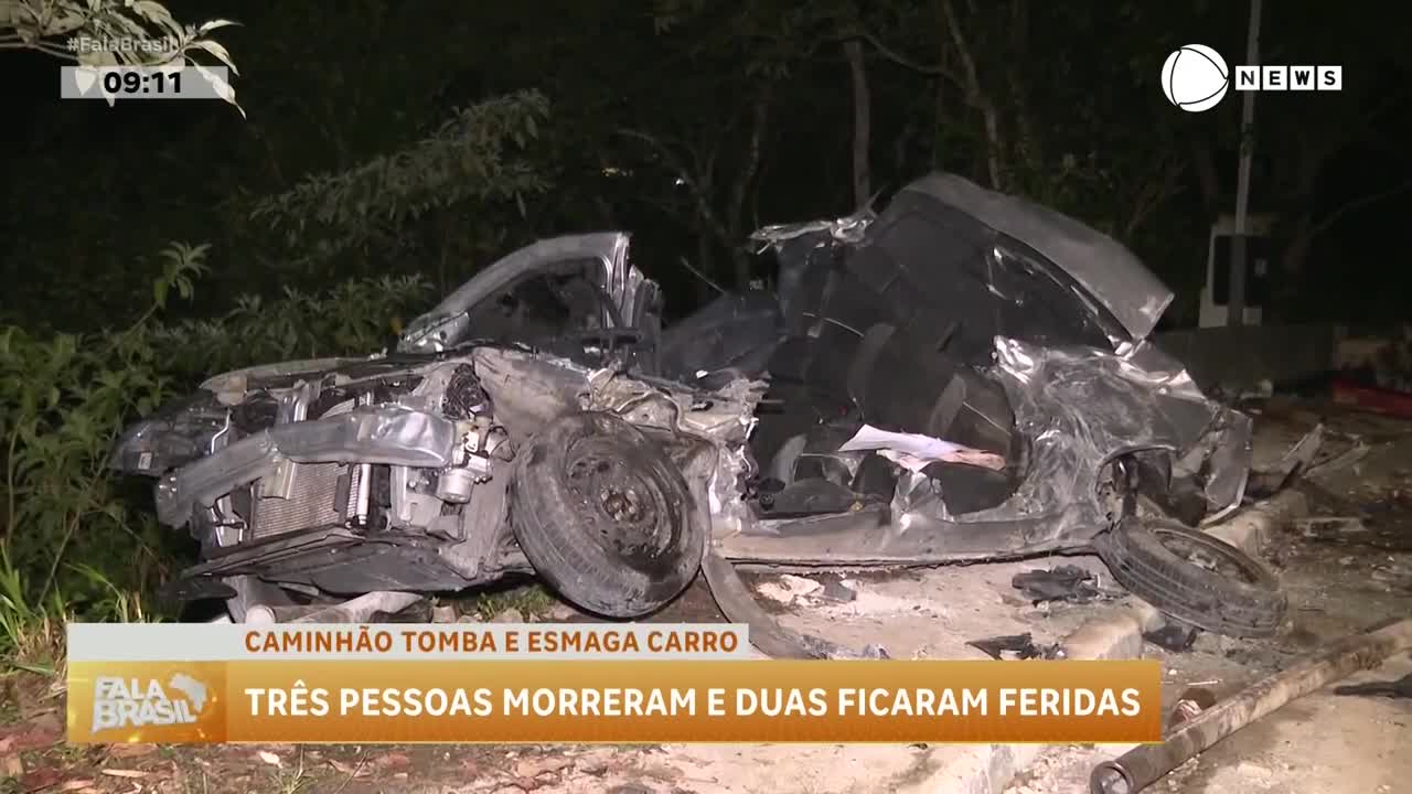 A crushed car sits on the roadside, its roof completely caved in. The Record News report from Brazil says three people died in the accident.
