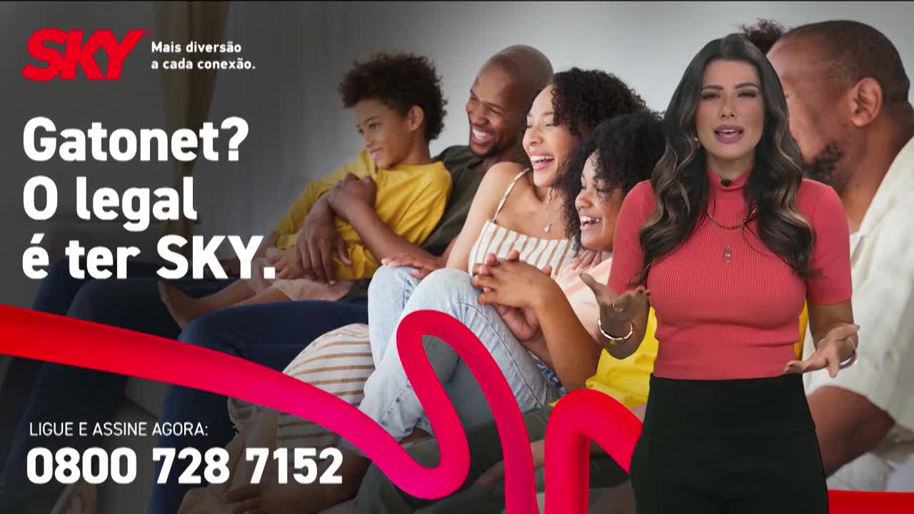 A woman in a coral shirt gestures as she speaks, standing in front of a family laughing together. A bright red ribbon snakes across the scene, framing the text and phone number.