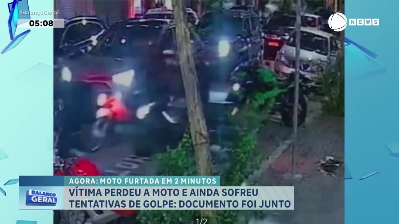 A motorcycle, its headlights glaring, is being pushed by two people down a street in Brazil. The scene, broadcast by Record News, shows the motorcycle being taken.