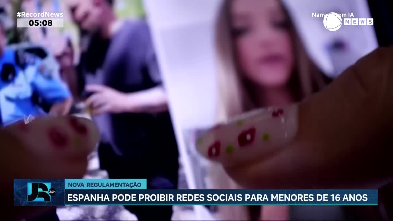 A hand with painted nails holds a photograph of a young woman. In the background, a man in a blue uniform stands beside another person.