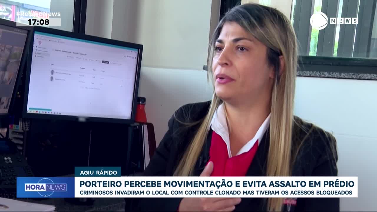 A woman speaks about a building's security system, her words overlaid with news text from Record News about a foiled robbery. A computer screen behind her displays a list of entries, with a red bottle standing nearby.