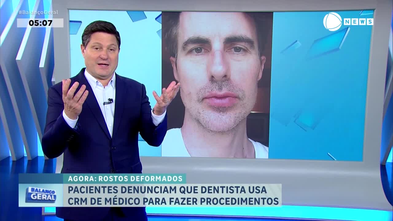 A man in a suit gestures emphatically as a screen behind him displays a close-up of another man's face. A news ticker below the faces reads "BALANÇO GERAL" and reports that patients are denouncing a dentist for using a medical license for procedures. A man in a suit gestures emphatically as a screen behind him displays a close-up of another man's face. A news ticker below the faces reads "BALANÇO GERAL" and reports that patients are denouncing a dentist for using a medical license for procedures.