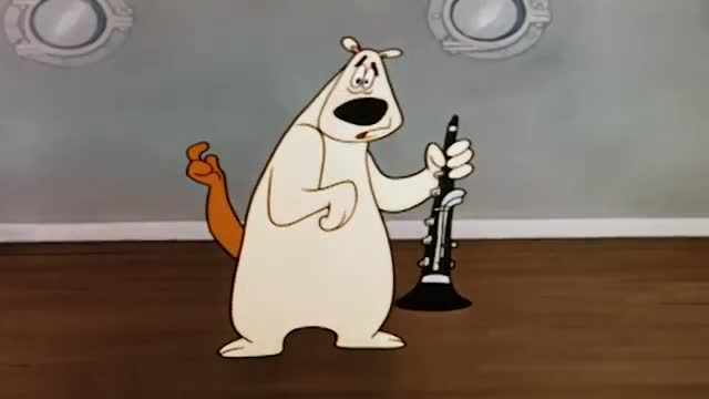 A white dog-like cartoon character, holding a clarinet, looks surprised with its mouth open. Its brown tail is curled behind it, and its other paw is raised.
