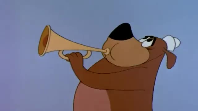 A brown bear with a black nose and a sailor hat is holding a golden trumpet to his lips. He's looking upward as he blows into the instrument.
