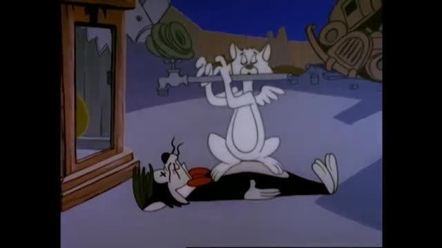A white cat sits atop a black and white cat, holding a faucet. The cat below appears to be struggling, eyes closed and mouth open.
