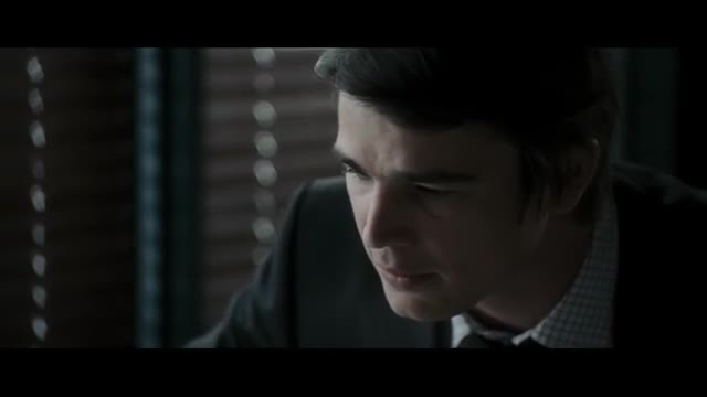 A man in a dark suit is looking down, his brow furrowed in concentration. The light catches his face, highlighting the lines around his eyes.
A man in a dark suit is looking down, his brow furrowed in concentration. The light catches his face, highlighting the lines around his eyes.