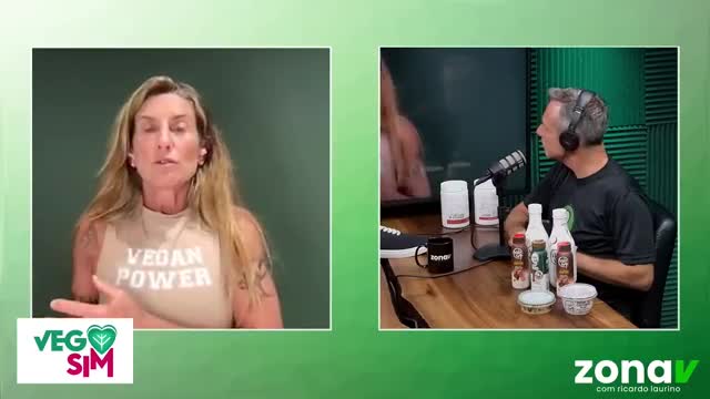 A woman with blonde hair, wearing a "Vegan Power" shirt, speaks directly to the camera. Beside her, a man with headphones listens intently, seated at a table with several bottles and containers.