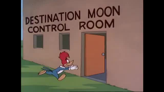 That woodpecker is sprinting towards an open door labeled "DESTINATION MOON CONTROL ROOM." He's wearing a blue jacket and white gloves, his arms outstretched as if to catch himself. That woodpecker is sprinting towards an open door labeled "DESTINATION MOON CONTROL ROOM." He's wearing a blue jacket and white gloves, his arms outstretched as if to catch himself.