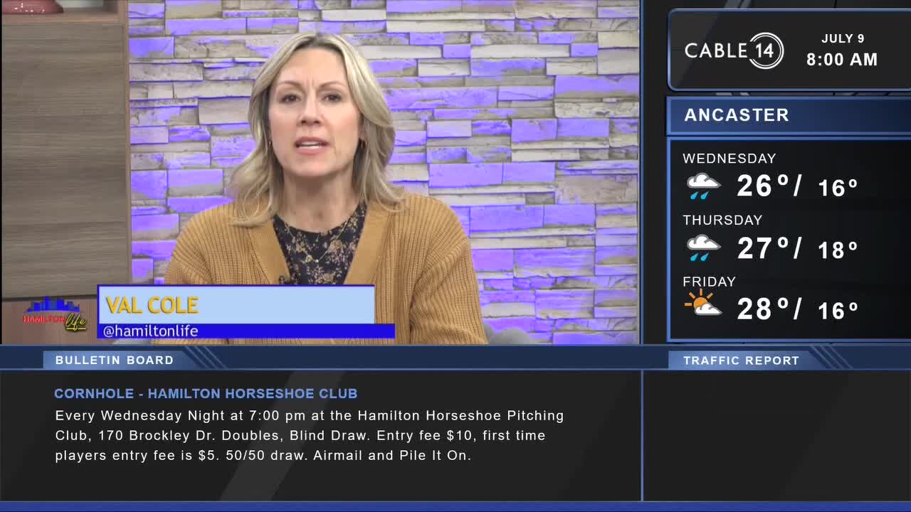 Cable 14 is on, and Val Cole is speaking from a studio in Canada. The screen beside her shows the weather forecast for Ancaster, with a bulletin board below advertising a cornhole night.

