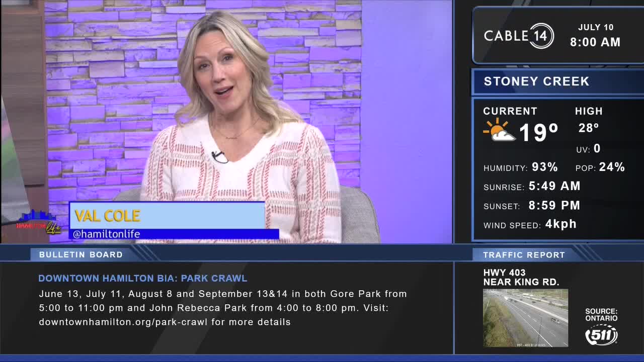 Val Cole from Cable 14 Hamilton is speaking, framed by a purple and blue backdrop. The screen displays the weather forecast for Stoney Creek and a traffic report for Highway 403.
