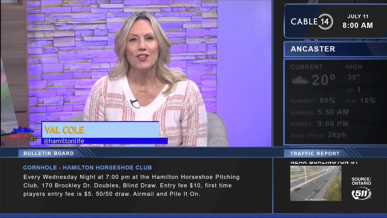 Val Cole from Cable 14 in Hamilton is speaking, her face framed by a light-colored sweater. The screen beside her shows the weather forecast for Ancaster.

