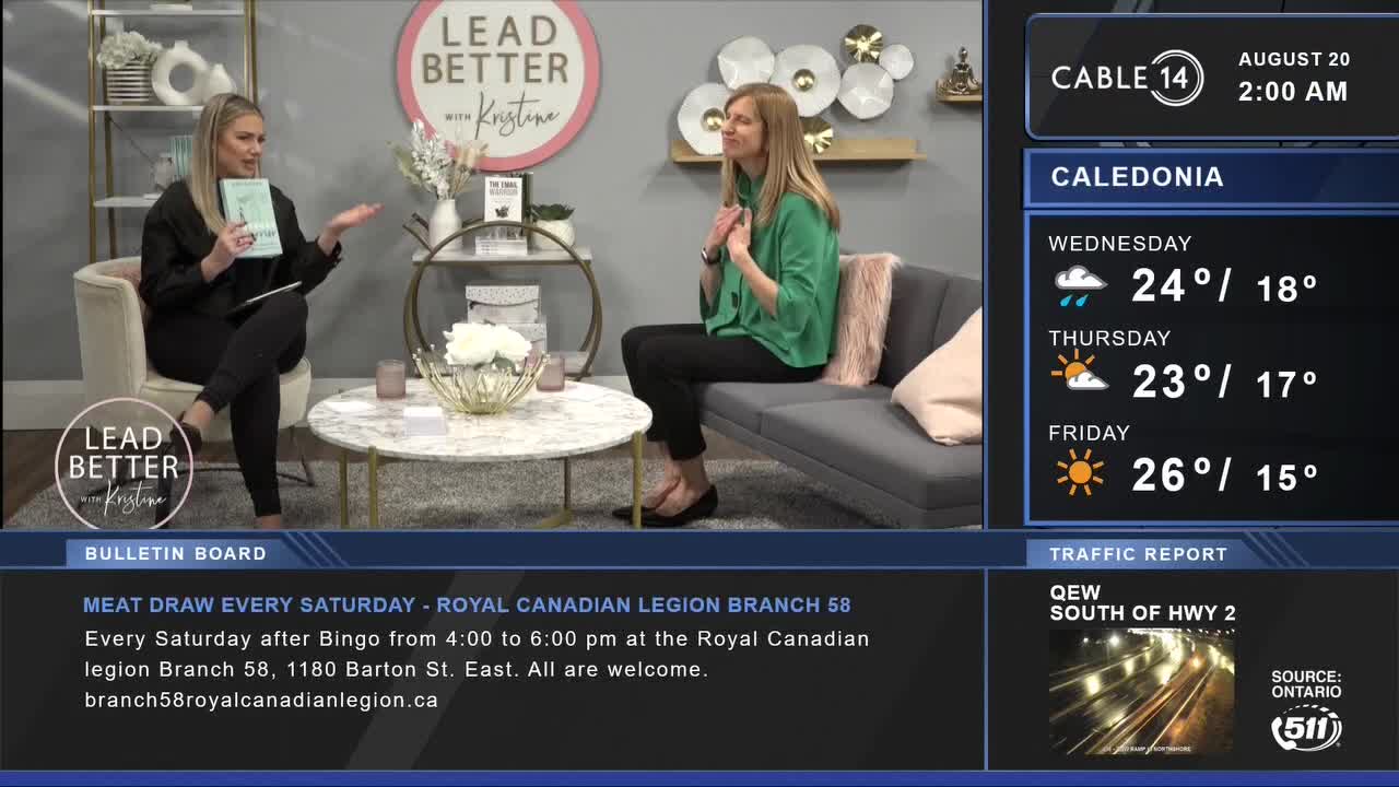 Two women are seated on a set, the one on the left holding a book and gesturing with her right hand. Cable 14 Hamilton is broadcasting the weather forecast for Caledonia, with the temperature for Friday at 26 degrees.
