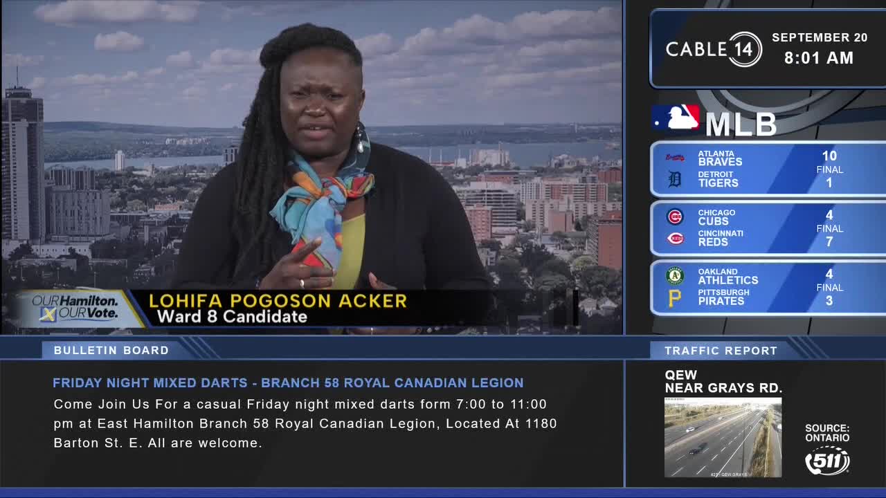 Lohifa Pogoson Acker, a Ward 8 candidate, speaks on Cable 14 Hamilton, with the city skyline visible behind her. Scores from MLB games and a traffic report from Ontario are displayed on the screen.
