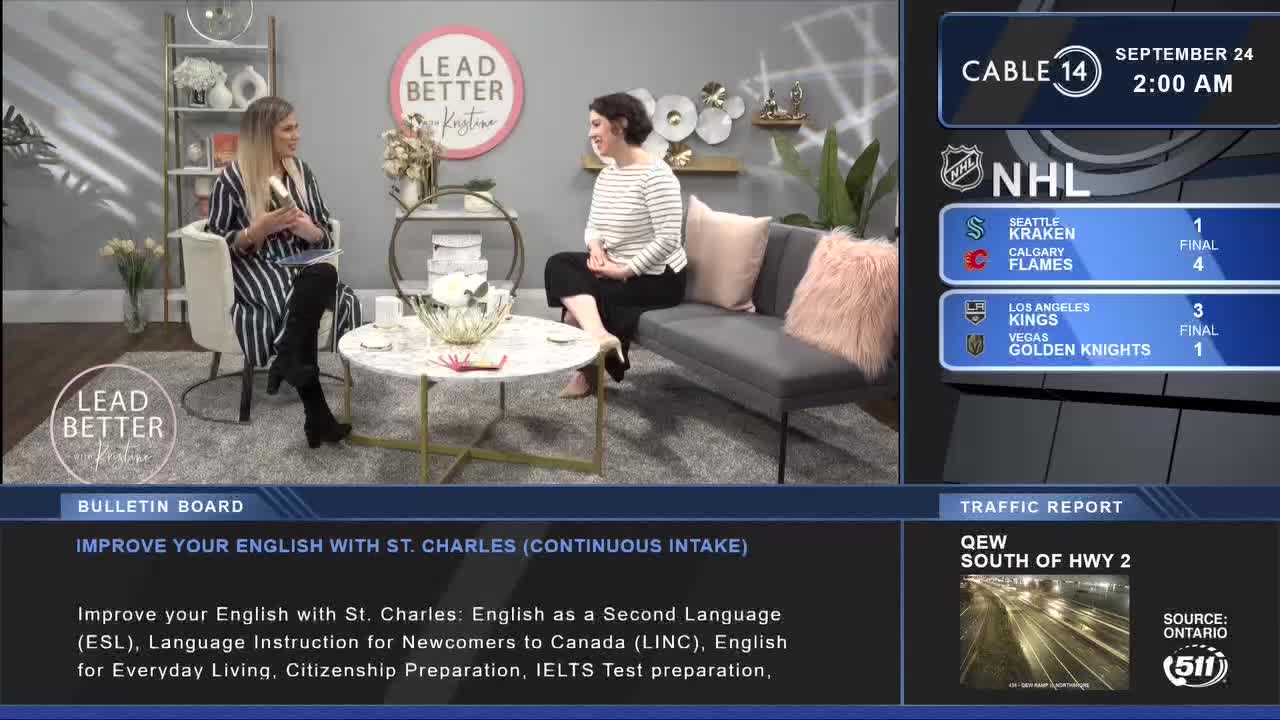 Two women are seated in a studio, chatting on Cable 14 Hamilton. The NHL scores flash on the screen, while a bulletin board promotes English lessons for newcomers to Canada.
