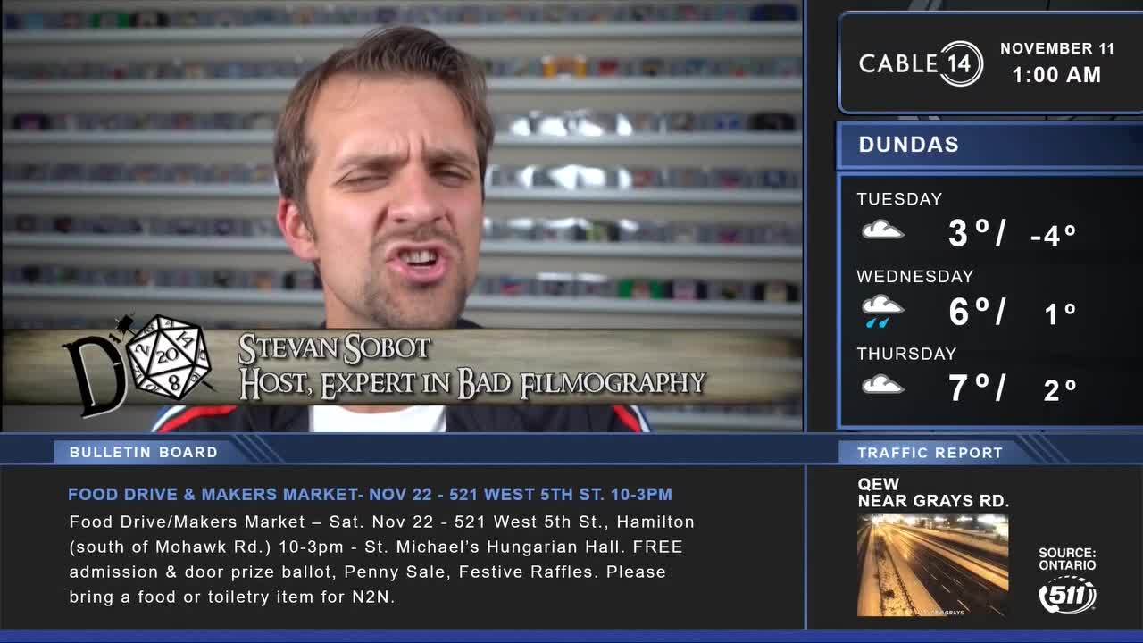 On Cable 14 Hamilton, a man with a serious expression is speaking, his name and title displayed below. The screen also shows the Dundas weather forecast and a bulletin for a local Food Drive and Makers Market.
On Cable 14 Hamilton, a man with a serious expression is speaking, his name and title displayed below. The screen also shows the Dundas weather forecast and a bulletin for a local Food Drive and Makers Market.