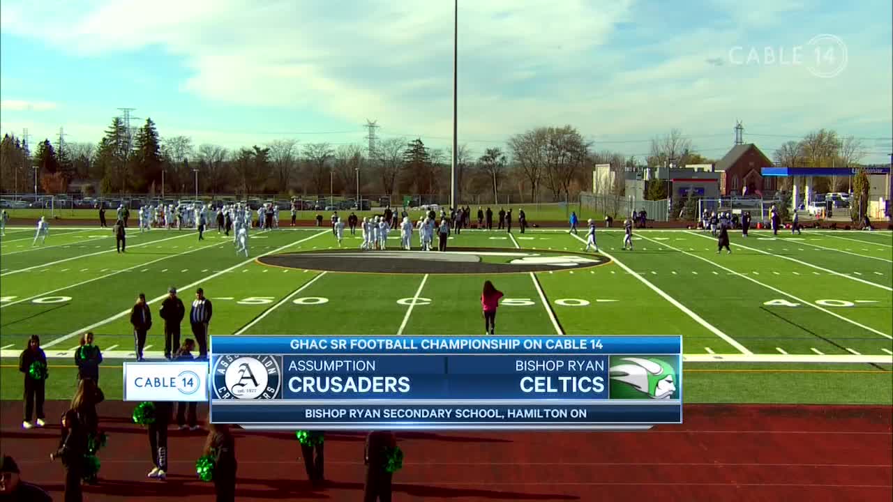 The Assumption Crusaders and Bishop Ryan Celtics are playing football, live on Cable 14 Hamilton. The teams are spread across the field, with the game underway under the autumn sky.
