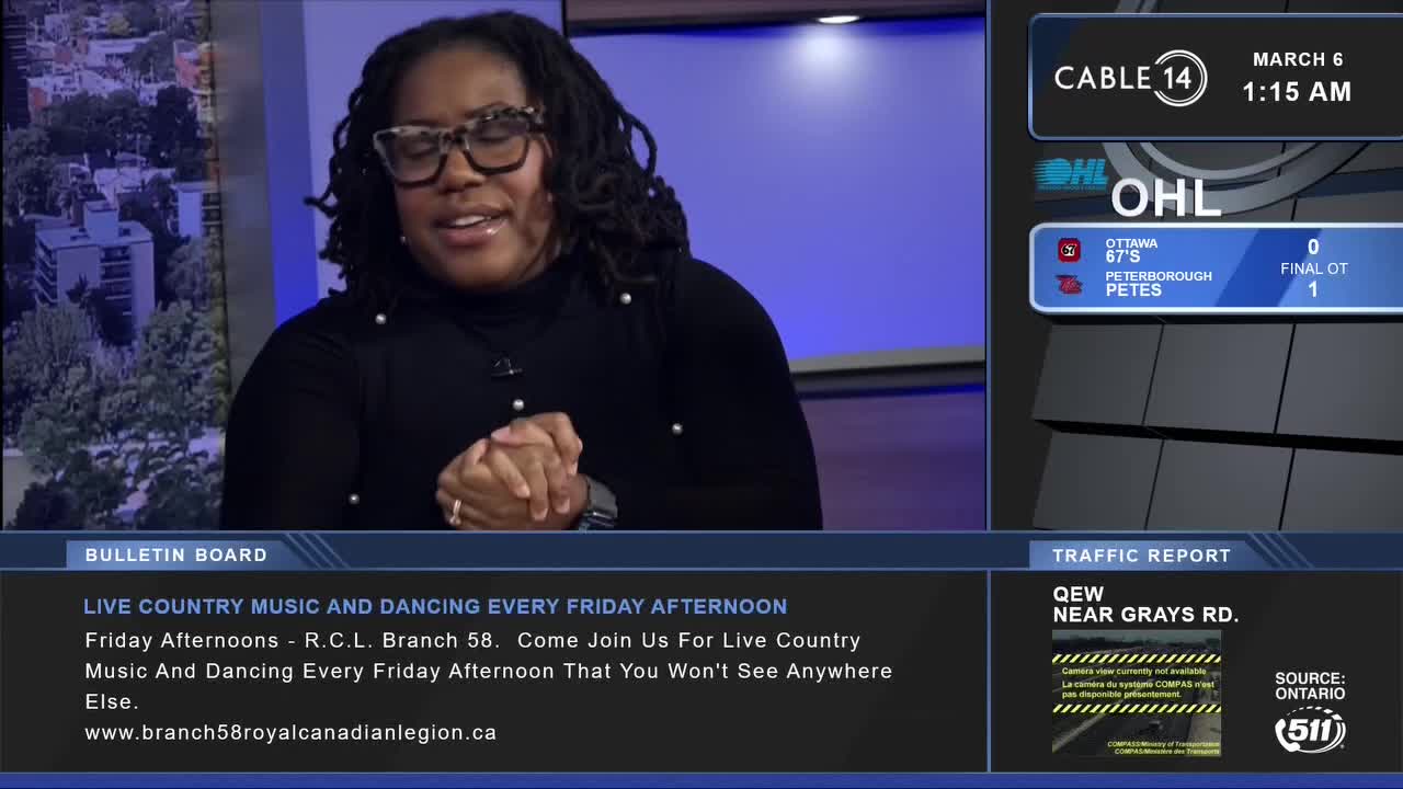 A woman with glasses and dreadlocks speaks, her hands clasped in front of her. A Cable 14 Hamilton graphic displays the OHL score, with Peterborough beating Ottawa in overtime.